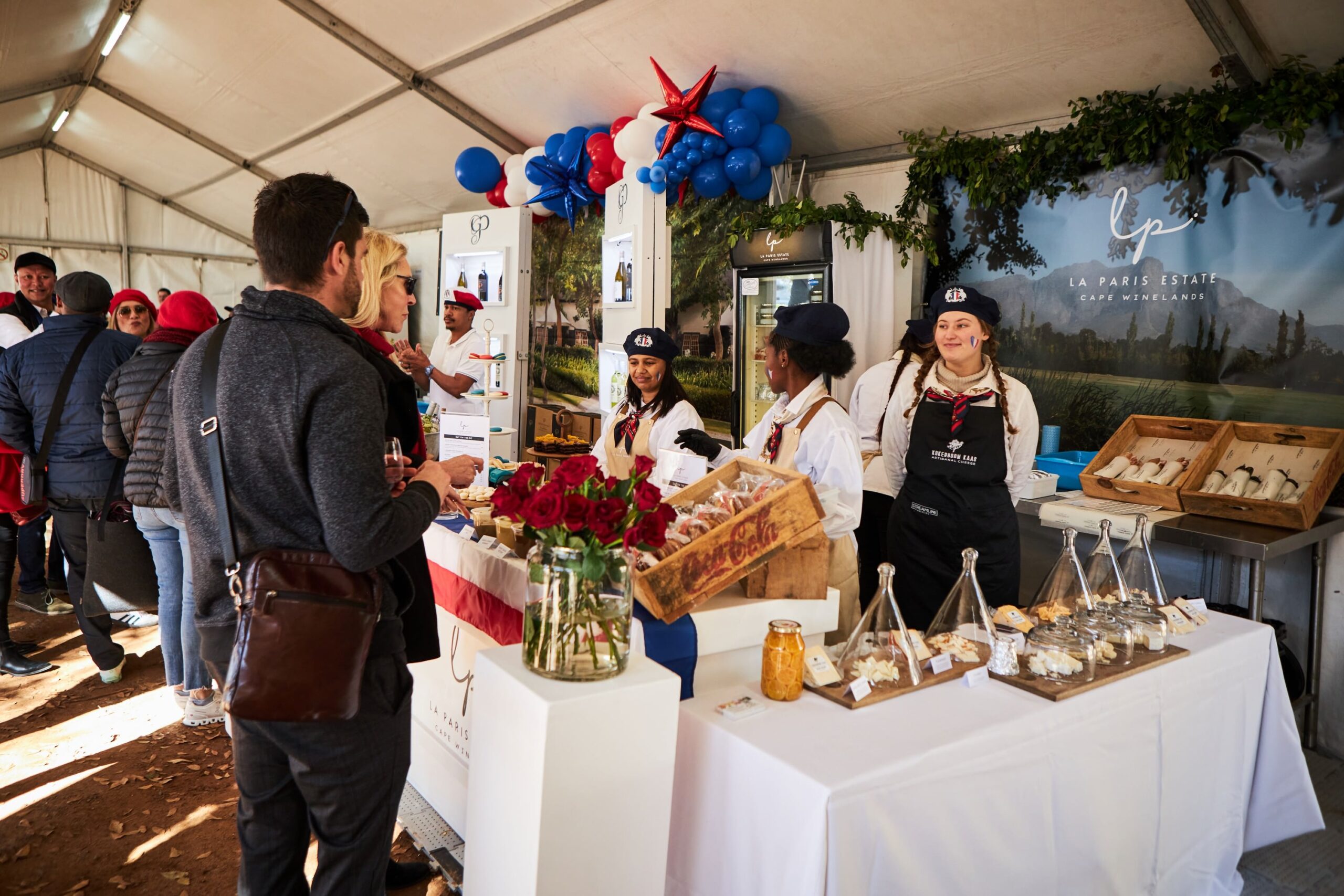 La Paris Estate vendor with staff serving guests at the Iconic Franschhoek Bastille Festival
